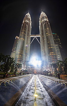 Fountain in front of illuminated Petronas Twin Towers at night, Kuala Lumpur, Malaysia, Asia