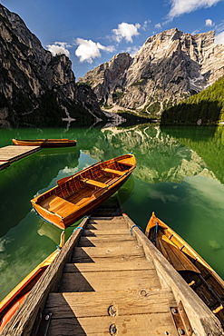 Stairs in mountain lake with boats, Seekogel peak in the back, Lake Prags, Dolomites, Italy, Europe