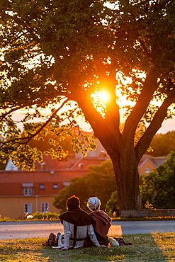 Visitors of the Medieval Week watch sunset over the Old Town, Visby, Gotland Island, Sweden, Europe