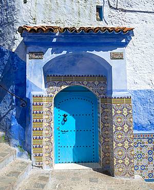 Facade, blue entrance door with colourful patterned tiles, blue house, Medina of Chefchaouen, Chaouen, Tangier-Tetouan, Morocco, Africa