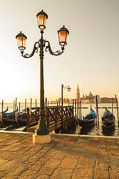 Lamppost with gondolas in San Marco and Benedictine church of San Giorgio Maggiore on San Giorgio Maggiore island, Venice, Veneto, Italy, Europe