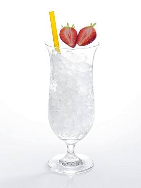 Glass prepared for cocktail, decorated with strawberries, drinking straw, crushed ice, Germany, Europe