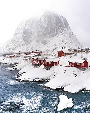 Snowstorm, red stilt houses, Hamnoy, drone shot, Lofoten, Norway, Europe