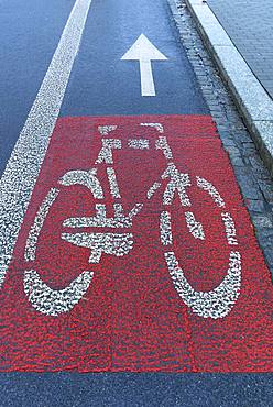 Red marked bicycle path on the roadway, Krakow, Poland, Europe