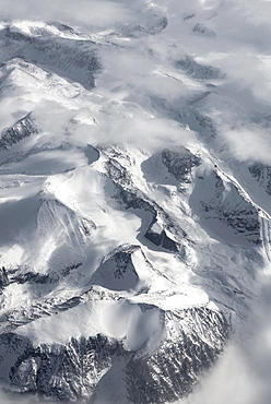 View from the plane to snow-covered mountainous landscape, bird's eye view, Greenland, North America