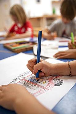 Children painting in kindergarten with crayons, Cologne, North Rhine-Westphalia, Germany, Europe