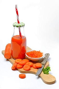 Carrot juice in bottle and carrot slices, Germany, Europe