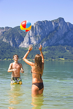 Two teenagers play with water polo in a lake, 18 years, Mondsee, Upper Austria, Austria, Europe