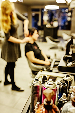 Cans of hairspray in a hairdressing salon, Hairdresser is doing the hair of a customer, North Rhine-Westphalia, Germany, Europe