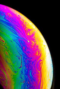 Soap bubble, detail with spectral colors, black background, studio shot, Austria, Europe