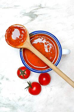 Cup with tomato soup and cooking spoon, Germany, Europe