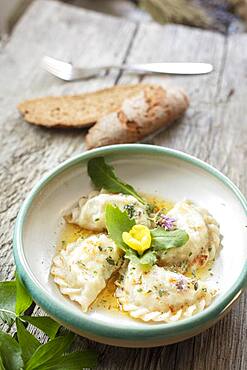 Carinthian noodles filled with herbs and cream cheese, melted butter, bread and lovage, Irschen, Carinthia, Austria, Europe