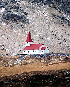 Small church with red roof in Vik from a distance, Vik, Iceland, Europe