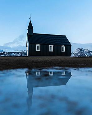 Black small church with reflection, Buakirkja, Arnarstapi, Iceland, Europe
