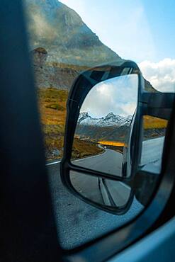 View of the fjord landscape through Campervan side mirror, Ramberg, Lofoten, Norway, Europe