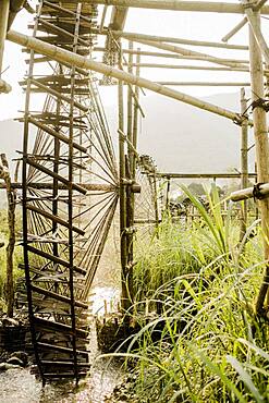 Irrigation of rice paddies with water wheels made of bamboo, Vietnam, Asia