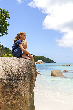 Girl on rocks, Anse Lazio, Praslin, Seychelles, Africa