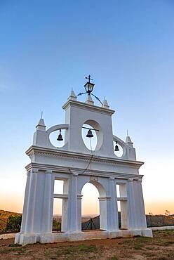 Bell tower of the chapel Ermita Reina de los Angeles, at sunset, Alajar, Huelva, Spain, Europe