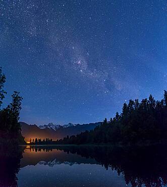 View of Mount Cook and Mount Tasman with starry sky and Milky Way, reflection in Lake Matheson, Westland National Park, New Zealand Alps, West Coast Region, South Island, New Zealand, Oceania