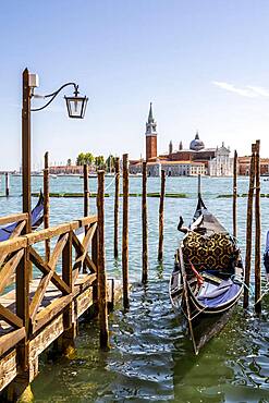 Venetian gondola in the lagoon, monastery San Giorgio Maggiore, district San Marco, Venice, region Veneto, Italy, Europe