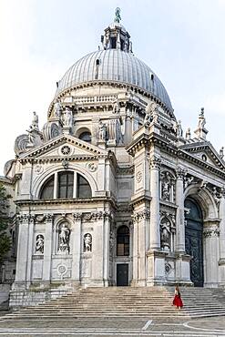 Young woman with in front of church, Basilica di Santa Maria della Salute, Venice, Veneto, Italy, Europe