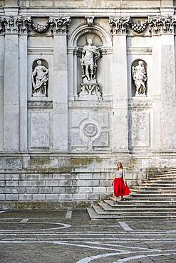 Young woman with red dress in front of white church, Basilica di Santa Maria della Salute, Venice, Veneto, Italy, Europe