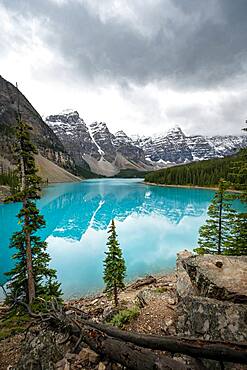 Clouds hanging between mountain peaks, reflection in turquoise glacial lake, Moraine Lake, Valley of the Ten Peaks, Rocky Mountains, Banff National Park, Alberta Province, Canada, North America