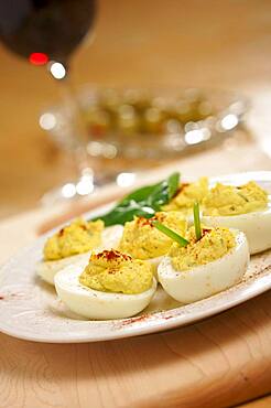 Deviled eggs and appetizers on a decorative white plate