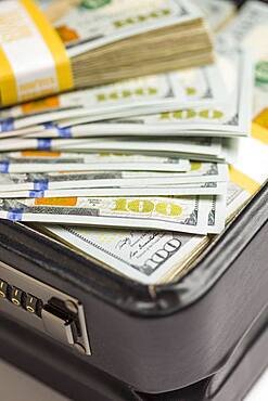 Abstract stacks of newly designed U.S. one hundred dollar bills in briefcase