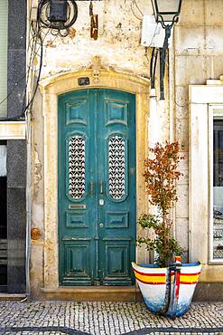 The turquoise wooden door on the promenade in Olhao, Algarve, Portugal, Europe