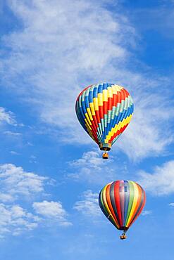 Beautiful hot air balloons against a deep blue sky and clouds