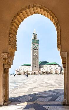 View through archway to Hassan II Mosque, Grande Mosquee Hassan II, Moorish architecture, with 210m highest minaret in the world, Casablanca, Morocco, Africa