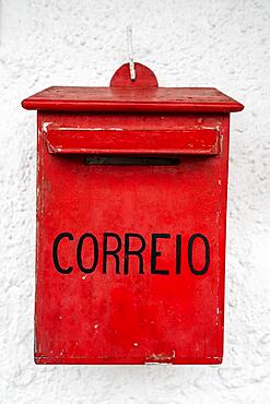 Vintage mail office box with portuguese word ""mail"" on white wall