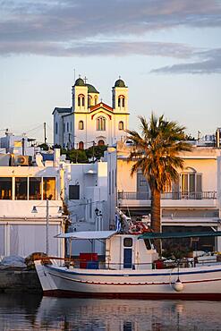 Evening atmosphere, city view, harbour with fishing boat and church, harbour town Naoussa, Paros Island, Cyclades, Greece, Europe