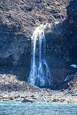 Waterfall along the coastline of the Unesco world heritage site Shiretoko National Park, Hokkaido, Japan, Asia