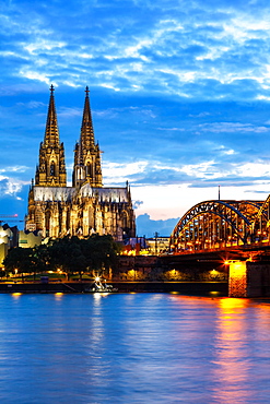 Cologne Cathedral Skyline and Hohenzollern Bridge with Rhine River in Germany at night in Cologne, Germany, Europe