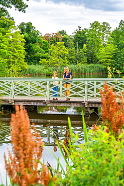 Woman and girl on a bridge over the machine pond, World Heritage Site Park Sanssouci, Potsdam, Brandenburg, Germany, Europe