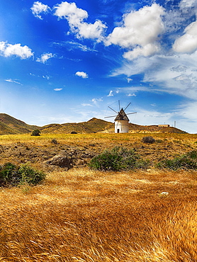 Windmill in barren landscape, Cabo de Gata Nijar Natural Park, San Jose, Almeria, Andalusia, Spain, Europe