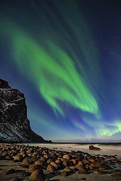 Northern lights (Aurora borealis) in winter Scandinavian landscape, sea, mountains, stars, Uttakleiv strand, Leknes, Nordland, Lofoten, Norway, Europe