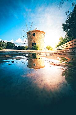 The Old Windmill in the Sunset with Reflection in a Puddle, Stone Windmill Zakyntos, Greece, Europe