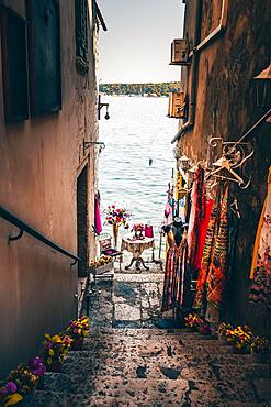 Exit to the sea, well-designed alley to a shop for clothes. Romantic place in the old town, Rovinj, Istria, Croatia, Europe