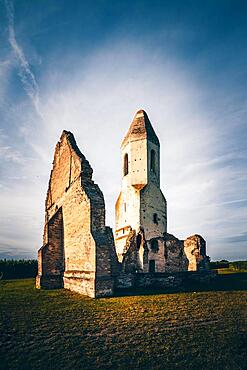 Ruin of a church in a cornfield. Old catholic church tower in the sunset, Pusztatorony, Somogyvamos at Lake Balaton, Hungary, Europe