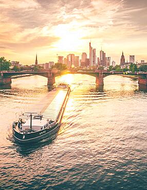 Skyline of Frankfurt's banking district, sunset, ship, view over a river, Frankfurt am Main, Hesse, Germany, Europe