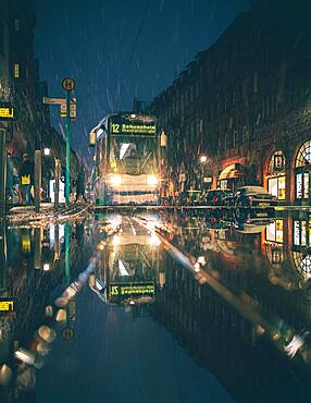 Tram at a stop in snow rain, puddle, evening, night and illuminated, Frankfurt am Main, Hesse, Germany, Europe