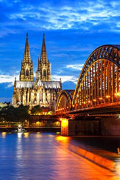 Cologne Cathedral Skyline and Hohenzollern Bridge with River Rhine in Germany at night in Cologne, Germany, Europe