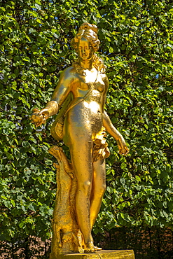 Boeotian Atalante in gold, statue by Heinrich Charasky, 18th century in the palace garden at Schwetzingen Palace, Baden-Wuerttemberg, Germany, Europe