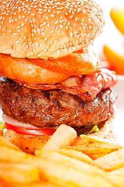 Classic american hamburger sandwich with onion rings and french fries