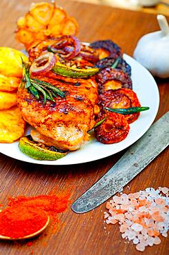 Roasted grilled BBQ chicken breast with herbs and spices rustic style