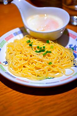 Traditional Japanese ramen noodles with poached egg on the side