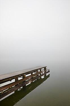 Abandoned bathing jetty in the morning mist, autumn landscape, Mondsee, Salzkammergut, Upper Austria, Austria, Europe